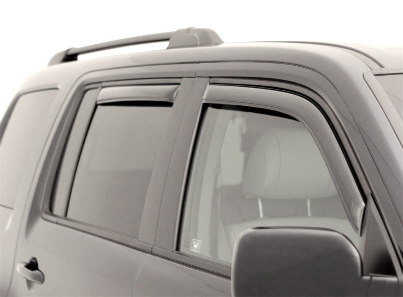 AVS smoke in-channel Ventvisor window deflectors installed on a 2021-2026 Chevrolet Tahoe, 4-piece set