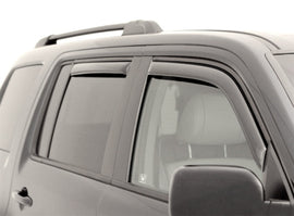 AVS smoke in-channel Ventvisor window deflectors installed on a 2021-2026 Chevrolet Tahoe, 4-piece set