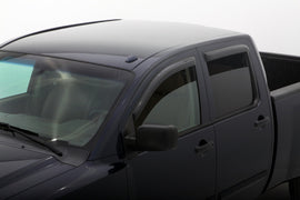 AVS smoke outside-mount window deflectors installed on a 2004-2015 Nissan Titan Crew Cab, 4-piece set