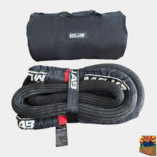 Load image into Gallery viewer, Durable 1.5" x 30' Kinetic Recovery Rope coiled neatly in breathable storage bag, designed for off-road enthusiasts.