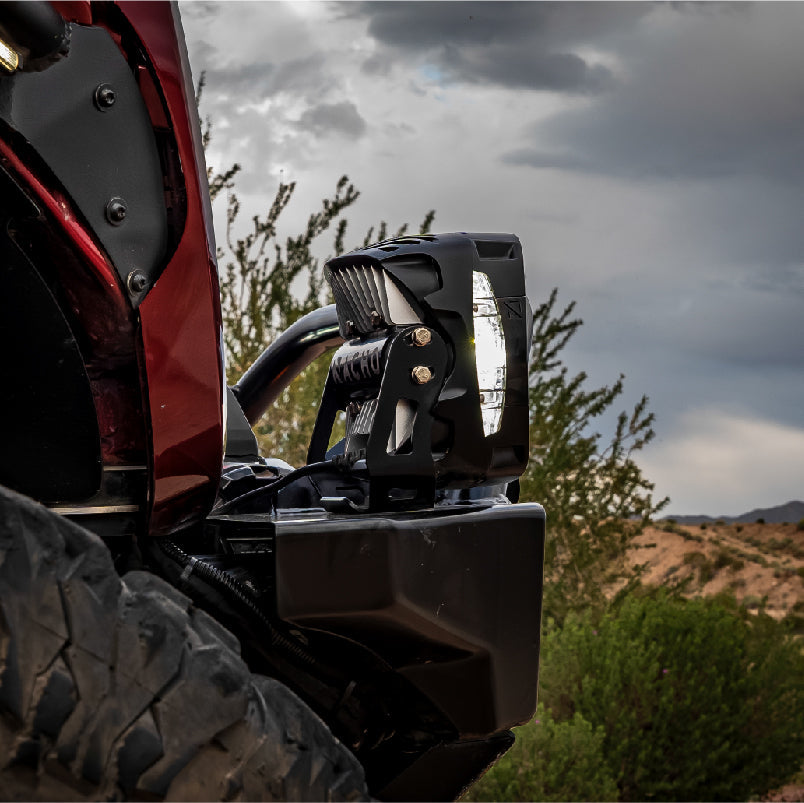 User adjusting the output settings on the NACHO Grande 4 Hi light for optimal use.