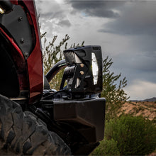 Load image into Gallery viewer, User adjusting the output settings on the NACHO Grande 4 Hi light for optimal use.