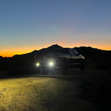 Load image into Gallery viewer, NACHO Quatro Off-Road light placed against an outdoor backdrop.