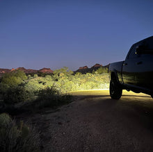 Load image into Gallery viewer, Installation process of NACHO Quatro Off-Road light on a vehicle.