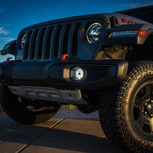 Load image into Gallery viewer, Nighttime driving with the Jeep JL/JT NACHO Plug N Play Fog Kit illuminating the path ahead.