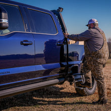 Load image into Gallery viewer, NACHO Quatro Off-Road light being tested in harsh weather conditions.