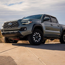 Load image into Gallery viewer, White light option of the TOYOTA SAE PLUG N PLAY FOG KIT shining bright on a Tacoma.