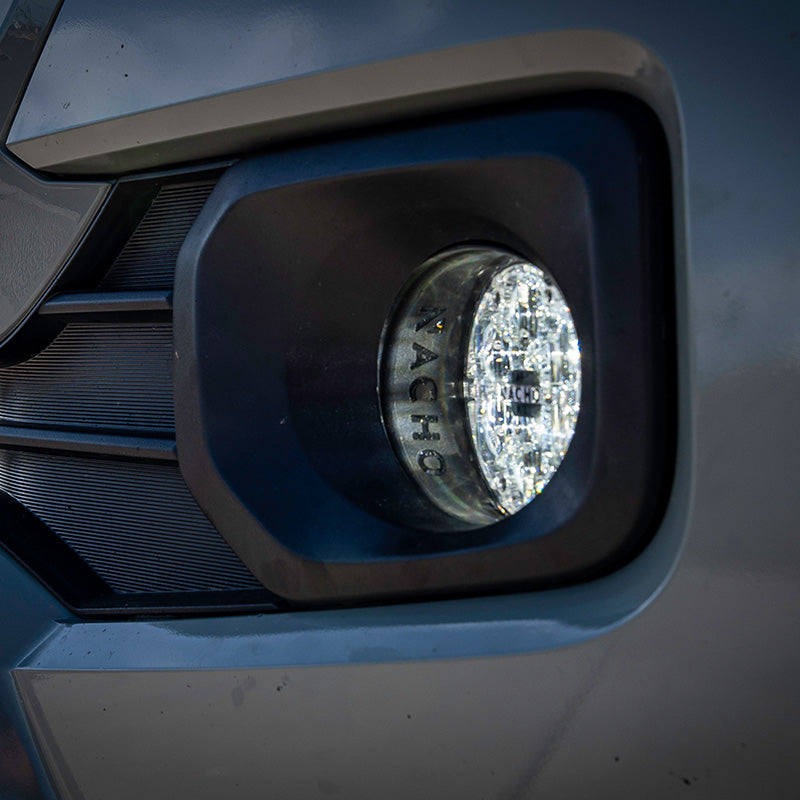 Side view of the Toyota SAE Plug N Play Fog Kit installed, showcasing its OEM fitment.