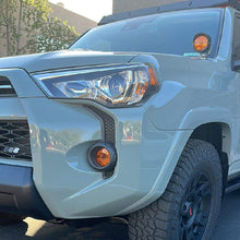 Load image into Gallery viewer, NACHO Quatro SAE illuminated in amber light during night offroad driving.