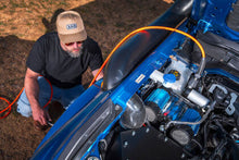 Load image into Gallery viewer, Installation example of the ARB Brushless Twin 12V On-Board Air Compressor Kit CKBLTA12 mounted in a vehicle.